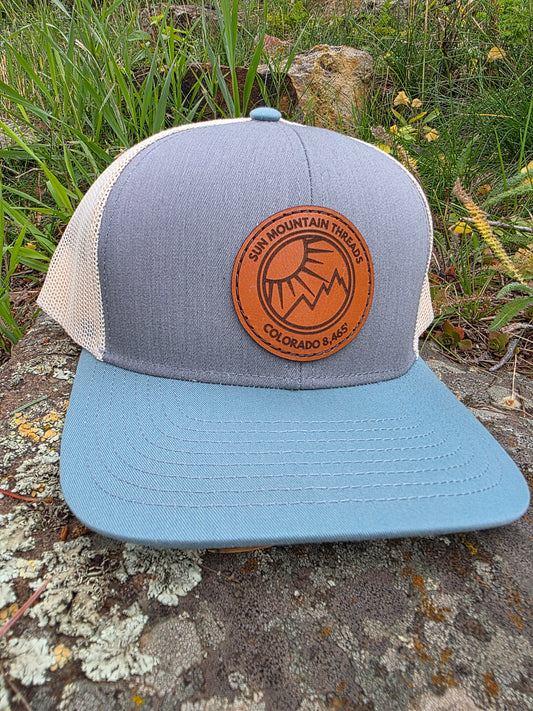Mountleisure - Sun Mountain Threads Leather Patch Trucker Hat CO 8,465 baby blue/ grey/ cream